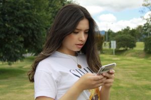 woman texting. Learn God's Voice by knowing his Character