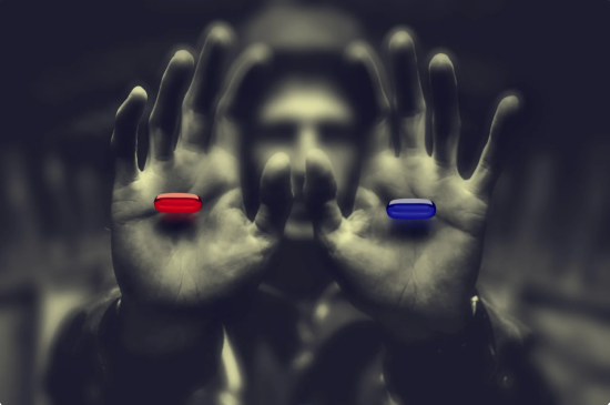 man holding a blue pill and a red pill, wake up and climb out of your coffin