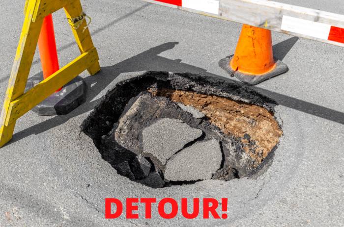 find your destiny in the potholes of life, pothole with detour sign